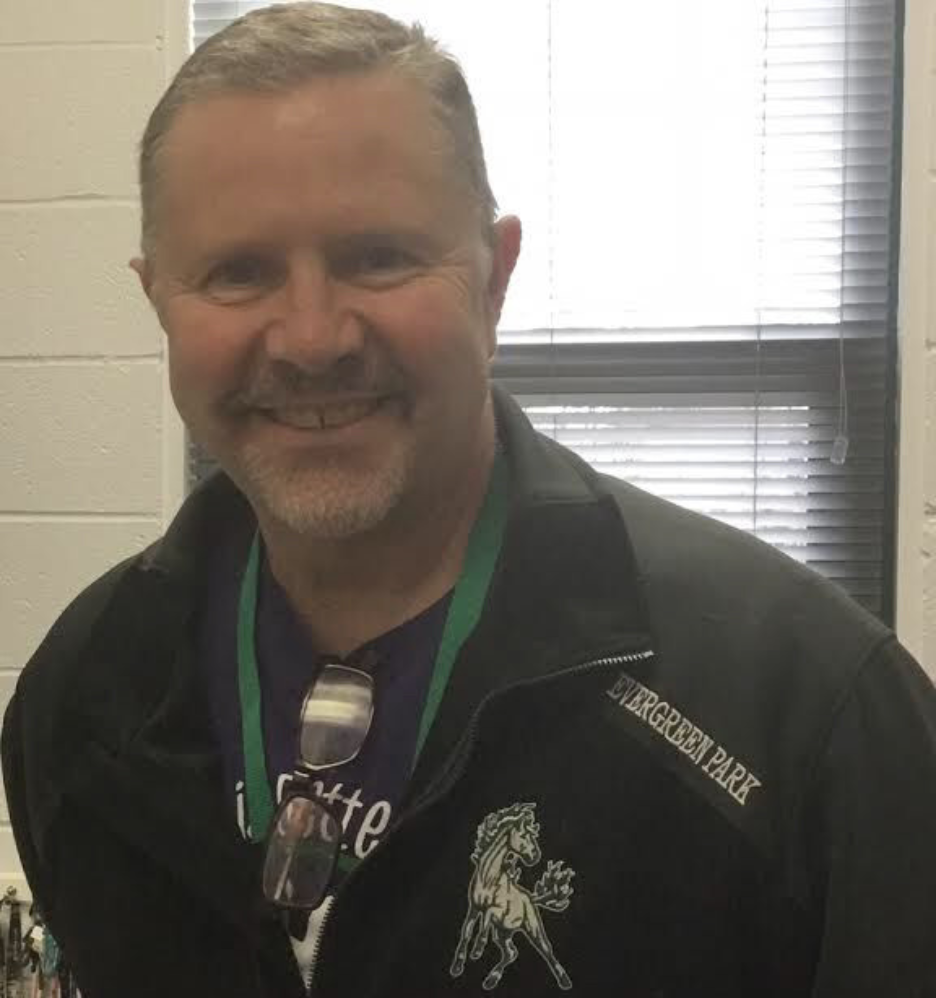 Ray Schellenberger smiling, wearing an Evergreen Park athletics jacket